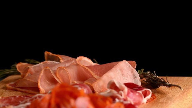 Traditional Iberian cold cuts and hams slices for appetizer on a rotating table