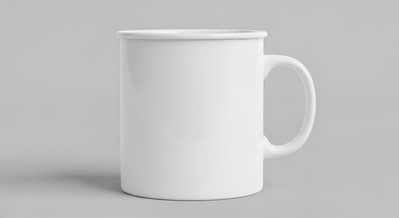 Obraz premium A simple white enamel mug with a sturdy handle stands against a plain light gray background with subtle shadow casting realism