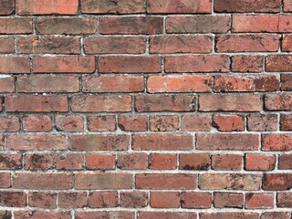Fototapeta premium Detailed background texture of a weathered red brick wall.