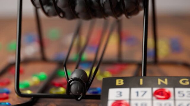 Grey bingo balls coming out of the spinning wheel