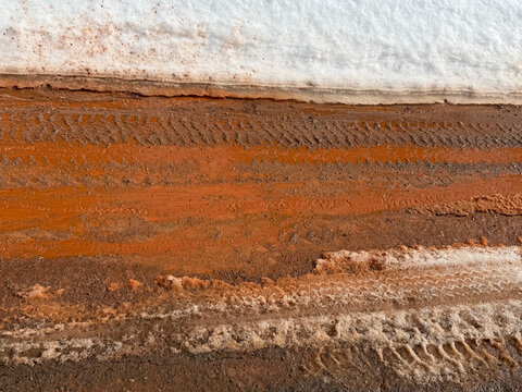 Rust-colored muddy water and slush during a winter thaw in the Michigan Upper Peninsula