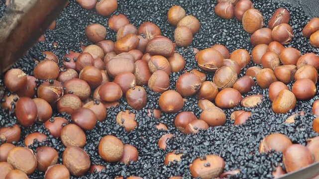 Roasted chestnuts in a pan.