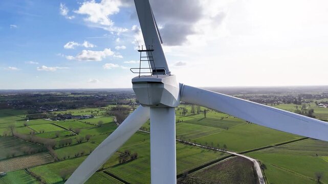 wind turbine three blades stretches across sunlit sky overlooking green fields winding rural roads energy's role sustainable electricity energy renewable technology 
