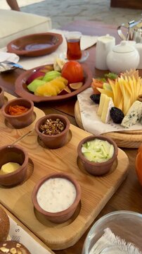 Royal Arabian all-inclusive breakfast with smoked salmon, cheese platter, basturma, fresh fruits and pastries. Elegant morning dining at a luxury resort terrace during a sunny summer vacation.