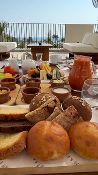 Royal Arabian all-inclusive breakfast with smoked salmon, cheese platter, basturma, fresh fruits and pastries. Elegant morning dining at a luxury resort terrace during a sunny summer vacation.