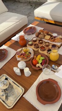 Royal Arabian all-inclusive breakfast with smoked salmon, cheese platter, basturma, fresh fruits and pastries. Elegant morning dining at a luxury resort terrace during a sunny summer vacation.