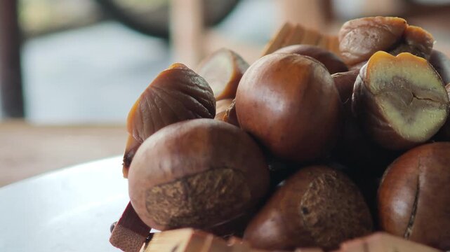 Roasted chestnuts in a container.