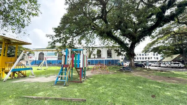 Colorful Outdoor Playground Equipment Under Large Shade Trees in Palau