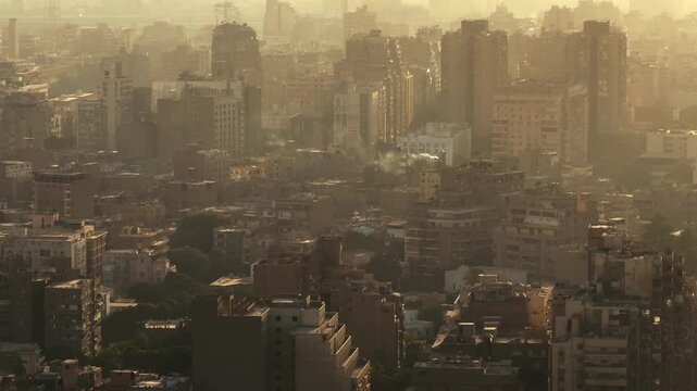 Aerial View of Cairo and Giza dense buildings silhouettes and layers at Golden Sunset
