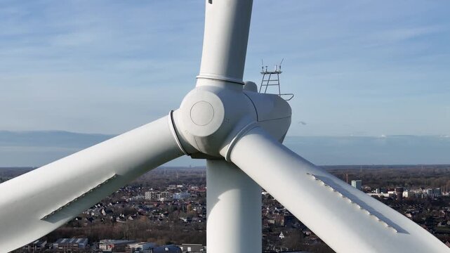 perspective wind turbine three blades densely built town open landscape renewable energy urban environment wide rotating aerial sweeping integration systems 