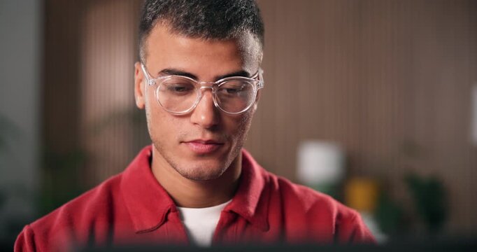 Review, glasses or man in office with laptop, draft edit or source feedback for article. Reading, specs or journalist in agency with tech, fact check or industry research for online publication.