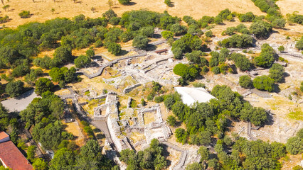 Tevfikiye, Turkey. Aerial view of the stone ramp and main gate of Troy II, with surrounding vegetation and trees on the mound of Hisarlik. Aerial view © Video Render