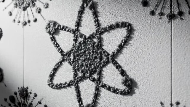 Close-Up of Atom Symbol Pattern on Textured Wall