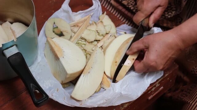 Breadfruit "Artocarpus incisus" which is peeled and then cut using a knife before being cooked
