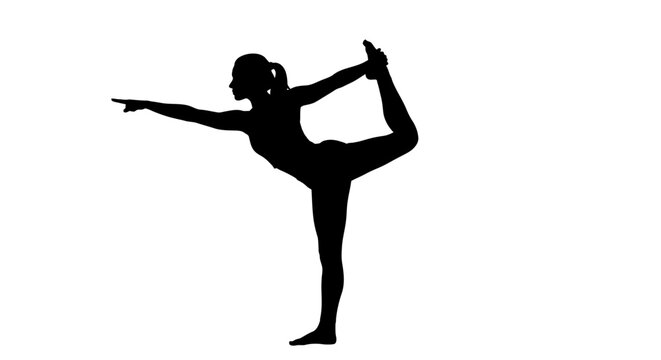 Silhouette of woman doing yoga pose.