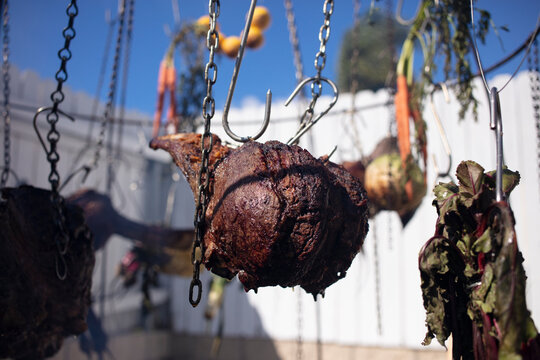 Hanging meat and vegetables over an open fire, the Australian bush cooking style. 