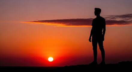 Obraz premium Silhouette of a man contemplating life at sunset.