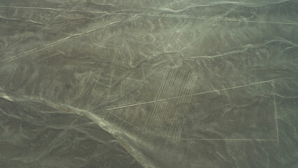 The Nazca Plateau. Aerial view. There are giant geoglyphs on the desert sand. Drawing of a monkey with a spirally curled tail, parallel lines. Peru. © Вера 