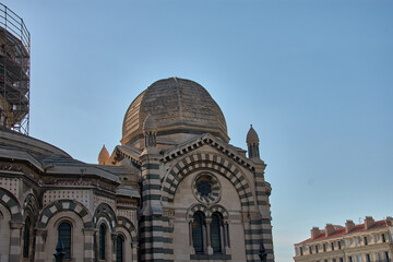 Obraz premium Domes and towers of the Marseille Cathedral of Sainte-Marie-Majeure in the La Joliette district, neo-Byzantine architecture under a blue sky