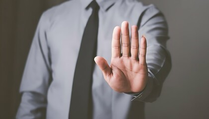 Obraz premium Businessman in Grey Shirt and Tie Showing Stop Gesture with Hand