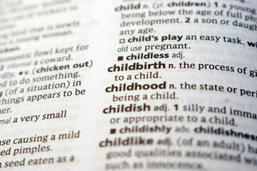 Fototapeta premium English Dictionary Page Close Up With The Word Transcription Of -childbirth