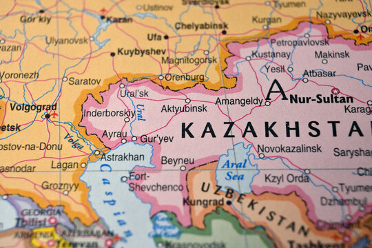 Defocused World Map Highlighting Aktobe Geography and Global Travel Concept