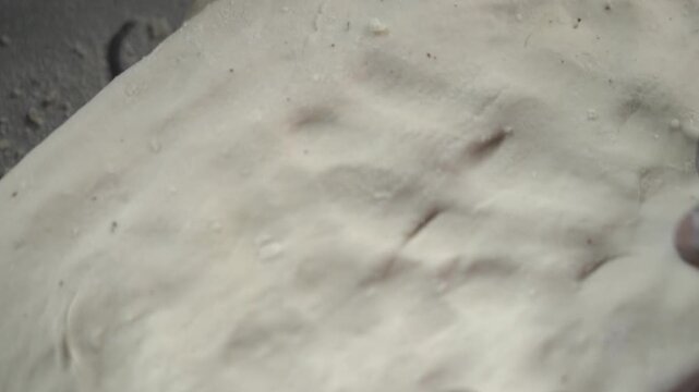 Traditional cooking process and texture of fresh dough used in Indian flatbread making. Naan Preparing.