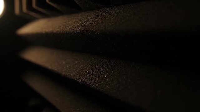 Close-up of soundproofing foam in dark recording studio, audio acoustics treatment detail.