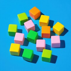 Obraz premium Colorful plastic building blocks scattered on a vibrant blue background creating an educational baby game layout with copy space for preschool marketing advertisements