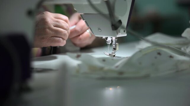 Tailor Adjusting Sewing Machine Settings. Fabric Artisan Carefully Calibrates Needle Pressure On Machine. Media