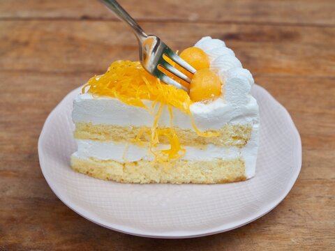 The cake, topped with shredded egg yolk and  gold egg yolks drops , is arranged on a plate. It looks delicious and sweet.