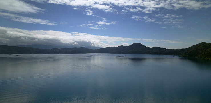 Serene lake with forested mountain slopes