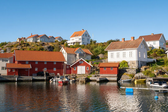 Traditional houses and boathouses on rocky waterfront in Gullholmen village on H&auml;rman&ouml; island, Bohusl&auml;n archipelago, west coast Sweden