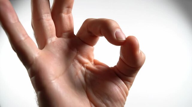 Hand making okay sign gesture.