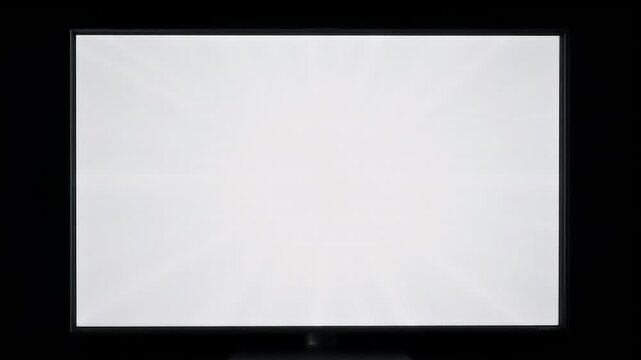 A flat screen television displaying a bright, nearly uniform white screen test