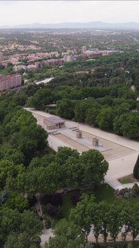 Historic Temple of Debod, highlighting its stone architecture and elevated park setting. Aerial Vertical
