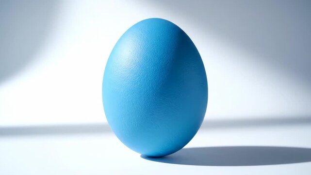 Blue easter egg spinning and balancing on white background