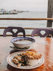 Fototapeta premium Seaside dining scene, Relaxed dockside meal with seafood and scenery