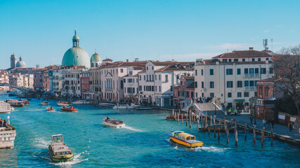 Venice Grand Canal with historic buildings and boats under a clear sky © george