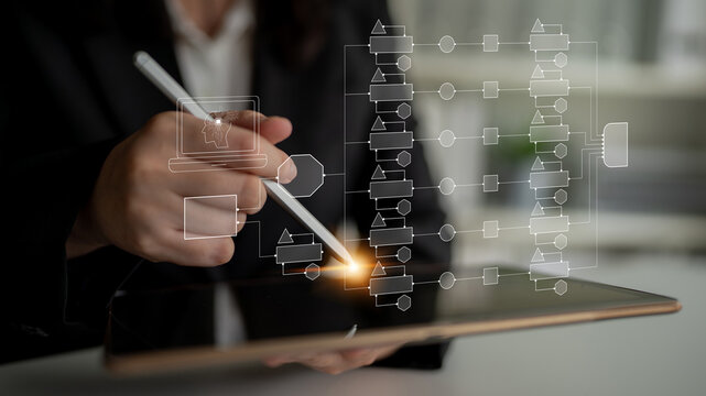 Professional businesswoman using digital tablet to create flowchart with stylus pen in modern office setting, showcasing innovative technology and productivity concepts Quark.