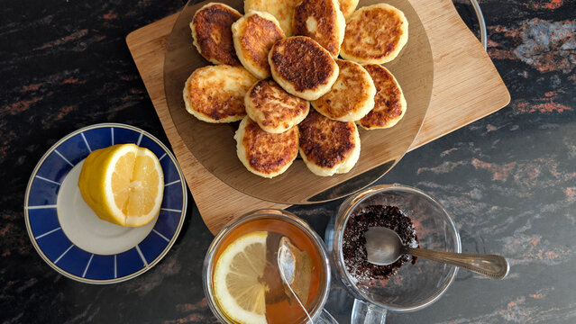 Platter Of Golden Curd Cheese Pancakes Served With Hot Lemon Tea
