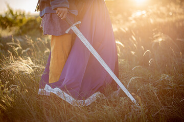 A woman and a man with a sword in medieval costume.