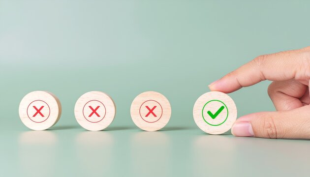 A hand selects a check mark instead of cross marks, implying a decision. The image shows the concept of choice, selection, and the correct answer.