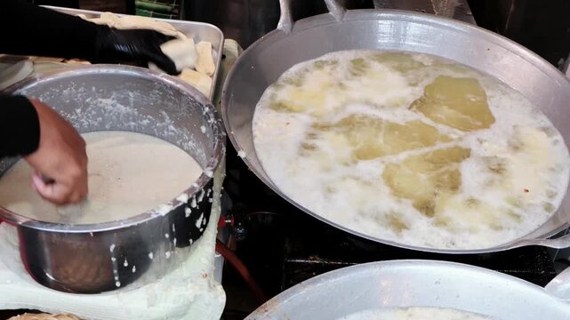 Footage of Thai Street Vendor Frying Crispy Batter-Coated Banana Snack