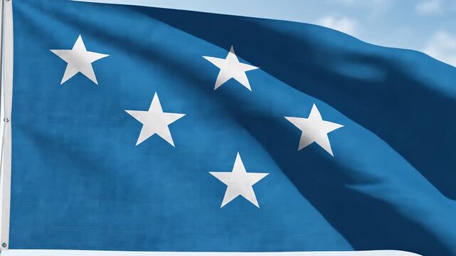 Waving blue flag with five white stars in a constellation pattern against a clear sky symbolizing unity achievement or a specific organization.