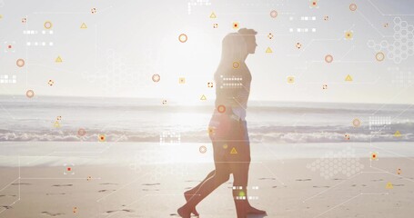 Naklejka premium Walking couple in swimwear strolling along wet sand with footprints near waves, digital overlays