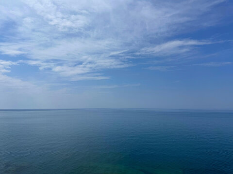 Open sea with calm water and cloudy sky.