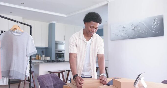 Man aligning box, opening and folding lid, checking tablet order, stacking packages for ecommerce
