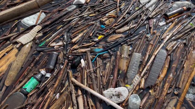 Heavy plastic garbage and organic waste floating on river surface, water pollution environmental disaster caused by household trash and debris clogging the natural aquatic ecosystem flow