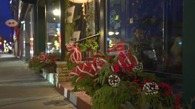 Christmas decorations outside a shop window with a slow panning shot at night